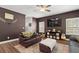 Inviting living room with a ceiling fan, neutral walls, and a brown leather couch at 560 Vandenburg Dr, Villa Rica, GA 30180
