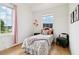 Cozy bedroom with twin beds, a view from two windows, and hardwood floors at 100 5Th St, Fayetteville, GA 30214