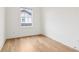 Empty bedroom with hardwood floors, white walls, and a bright window at 100 5Th St, Fayetteville, GA 30214
