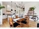 Open-concept dining area featuring hardwood floors, modern lighting, and seamless flow to the kitchen and living spaces at 100 5Th St, Fayetteville, GA 30214