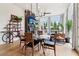 Stylish dining area with a modern chandelier, hardwood floors, and open layout connecting to the living room and outdoor patio at 100 5Th St, Fayetteville, GA 30214