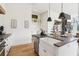 Modern kitchen featuring white cabinets, a farmhouse sink, stone countertops and stainless steel appliances at 100 5Th St, Fayetteville, GA 30214