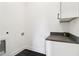 Clean, simple laundry room with a dark countertop, perfect for everyday tasks at 100 5Th St, Fayetteville, GA 30214