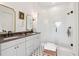 Bright main bathroom featuring dual sinks, gray countertops, white cabinetry, and a glass shower at 100 5Th St, Fayetteville, GA 30214