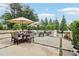 Wide shot of patio with outdoor furniture, including dining table, chairs, and umbrellas for comfortable backyard living at 100 5Th St, Fayetteville, GA 30214