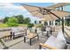 Spacious patio with modern seating arrangements, umbrellas, and lush greenery for relaxing and entertaining at 100 5Th St, Fayetteville, GA 30214