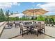 Relaxing backyard patio featuring a dining set with six chairs, two umbrellas, and comfortable lounge furniture at 100 5Th St, Fayetteville, GA 30214