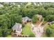 Aerial view featuring several homes surrounded by lush trees in a suburban neighborhood at 1335 Joy Ct, Suwanee, GA 30024