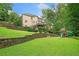 Large backyard with terraced landscaping, a deck, and a play set at 1335 Joy Ct, Suwanee, GA 30024