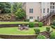 Backyard featuring an outdoor seating area and tiered landscaping with stone retaining walls at 1335 Joy Ct, Suwanee, GA 30024