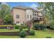 Expansive backyard with multi-level patio, mature trees, and lush landscaping at 1335 Joy Ct, Suwanee, GA 30024