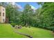 Expansive backyard features lush greenery, outdoor seating, and a playground at 1335 Joy Ct, Suwanee, GA 30024