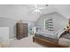 Comfortable bedroom featuring a desk, a dresser, and a bed under a ceiling fan at 1335 Joy Ct, Suwanee, GA 30024