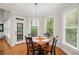Charming breakfast nook features hardwood floors, natural light, and a modern pendant light at 1335 Joy Ct, Suwanee, GA 30024