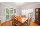 Charming dining room with hardwood floors, natural light, and traditional wooden table and chairs at 1335 Joy Ct, Suwanee, GA 30024