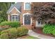 Inviting front entrance with double doors, decorative wreaths, and lush landscaping at 1335 Joy Ct, Suwanee, GA 30024