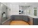 Modern kitchen boasts stainless steel appliances, gray cabinets, and bright white counters and cabinets at 1335 Joy Ct, Suwanee, GA 30024