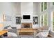 Bright living room with a stone fireplace, built-in bookshelves, and plenty of natural light at 1335 Joy Ct, Suwanee, GA 30024
