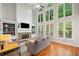 Bright living room with large windows, a fireplace, and hardwood floors at 1335 Joy Ct, Suwanee, GA 30024