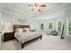 Spacious primary bedroom suite features a ceiling fan, tray ceiling, and large windows at 1335 Joy Ct, Suwanee, GA 30024