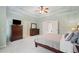 Comfortable primary bedroom with tray ceiling, furniture, and easy access to attached rooms at 1335 Joy Ct, Suwanee, GA 30024
