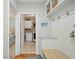 Well-organized mud room features built-in bench, storage, and convenient access to laundry area at 1335 Joy Ct, Suwanee, GA 30024