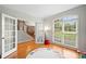 Sunlit office with French doors, hardwood floors, and a view of the front yard at 1335 Joy Ct, Suwanee, GA 30024
