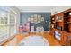 Spacious playroom with large windows, hardwood floors, and built-in shelving at 1335 Joy Ct, Suwanee, GA 30024