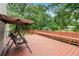 Relaxing back deck features a swing and built-in seating overlooking a lush yard at 1732 Winding Woods Ln, Jonesboro, GA 30236
