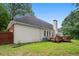 Side view of a white house with a wooden deck and privacy fence in the backyard at 1732 Winding Woods Ln, Jonesboro, GA 30236