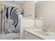 Cozy bathroom with tub/shower combo, decorative shower curtain, and classic fixtures at 1732 Winding Woods Ln, Jonesboro, GA 30236