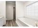 Bright bathroom featuring a soaking tub, a walk-in shower, and neutral finishes at 1732 Winding Woods Ln, Jonesboro, GA 30236