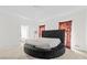 Spacious bedroom featuring a modern, round upholstered bed and decorative drapes at 1732 Winding Woods Ln, Jonesboro, GA 30236