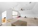 Spacious bonus room featuring a ceiling fan, carpeted floors, and lots of natural light at 1732 Winding Woods Ln, Jonesboro, GA 30236