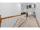 Spacious hallway with white railings and a view of the living and dining areas at 1732 Winding Woods Ln, Jonesboro, GA 30236