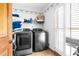A modern laundry room with newer machines and plenty of storage at 1732 Winding Woods Ln, Jonesboro, GA 30236