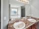 Bathroom vanity features dual sinks, granite countertop, cabinet and large mirror at 176 Windy Cir, Mcdonough, GA 30253