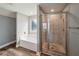 Bathroom with tile floor, soaking tub under window, and glass enclosed tile shower at 176 Windy Cir, Mcdonough, GA 30253