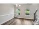 Bright, open dining room with hardwood floors, large windows, and classic trim, ready for your personal touch at 176 Windy Cir, Mcdonough, GA 30253