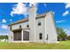 View of back of home with screened in porch, grassy yard and blue sky at 176 Windy Cir, Mcdonough, GA 30253