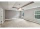 Bright, spacious main bedroom with a tray ceiling, neutral walls, carpeted floors, and ample natural light at 176 Windy Cir, Mcdonough, GA 30253