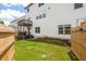 Spacious backyard with a wooden fence, lush green grass, and a small patio deck at 2039 West Hampton Dr, Canton, GA 30115
