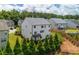 A backyard view of a two-story house with manicured landscaping, a small balcony and privacy fence at 2039 West Hampton Dr, Canton, GA 30115