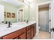 Bathroom with a double vanity, wooden cabinets, and a separate shower room at 2039 West Hampton Dr, Canton, GA 30115