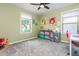 Bright bedroom featuring plush gray carpet, neutral green walls, and bright artwork at 2039 West Hampton Dr, Canton, GA 30115