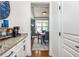 Butler's pantry area with granite countertops leading into the dining room at 2039 West Hampton Dr, Canton, GA 30115