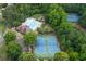 Aerial view of the community pool, tennis courts, clubhouse, playground, and lush greenery at 2039 West Hampton Dr, Canton, GA 30115