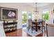 A dining area with a dark wood table, matching chairs, hardwood floors, and natural light at 2039 West Hampton Dr, Canton, GA 30115