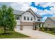 Charming two-story home with white siding, brick accents, three-car garage, and landscaped yard at 2039 West Hampton Dr, Canton, GA 30115