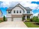 Charming two-story home featuring a three-car garage, brick accents, and manicured landscaping at 2039 West Hampton Dr, Canton, GA 30115